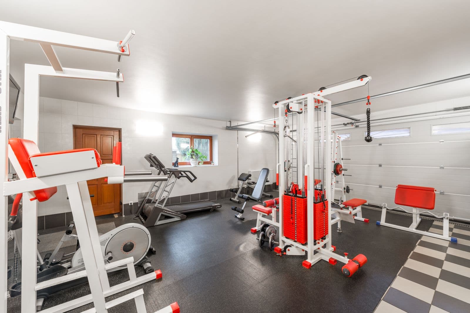 Bright, organized two-car garage planned as a home gym and family workout space